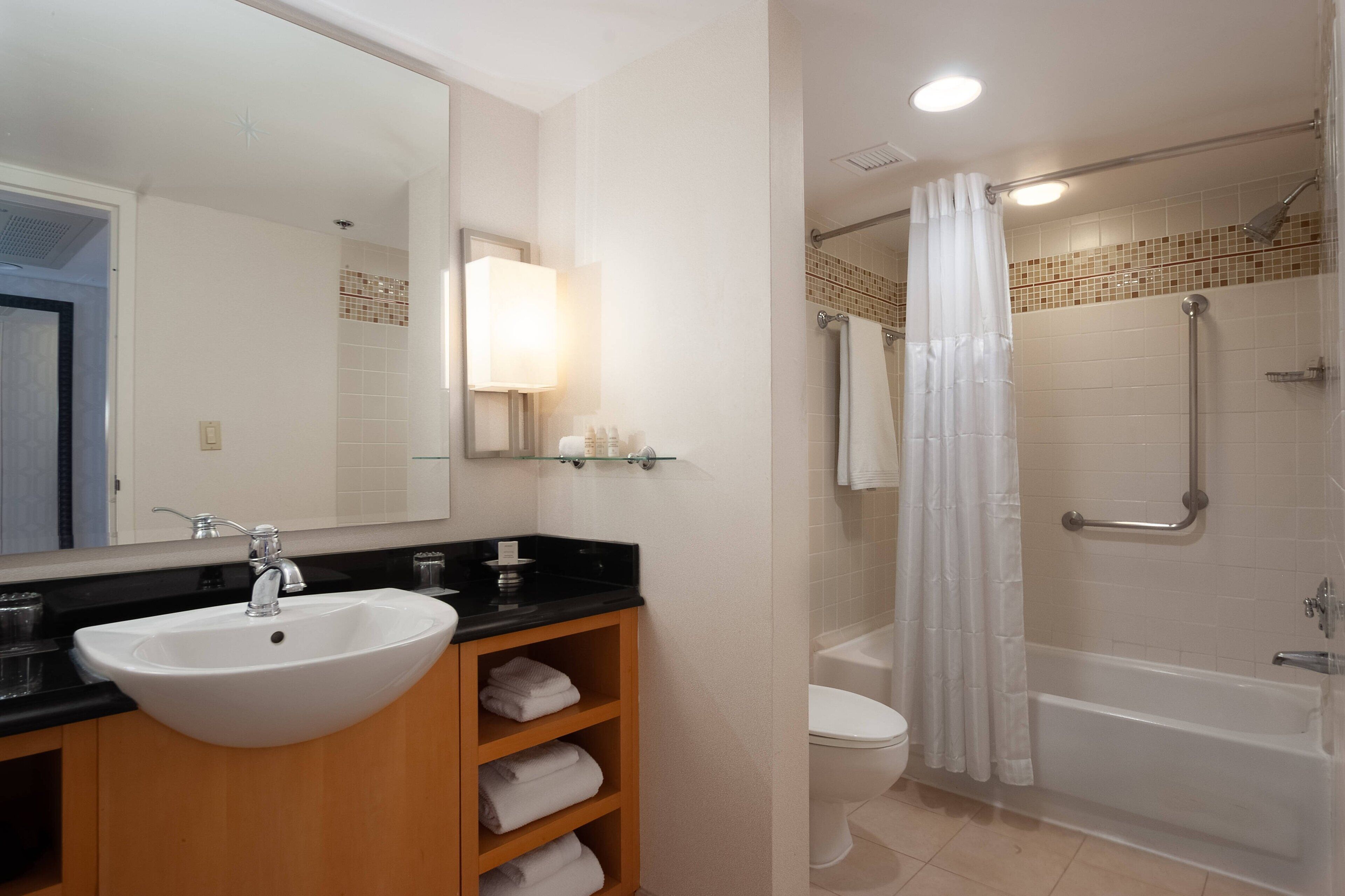 designer toiletries, hair dryer, towels