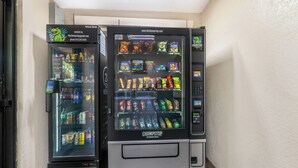 Two vending machines with a variety of snacks and drinks.