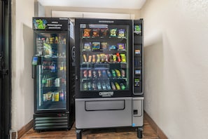 Two vending machines with a variety of snacks and drinks.