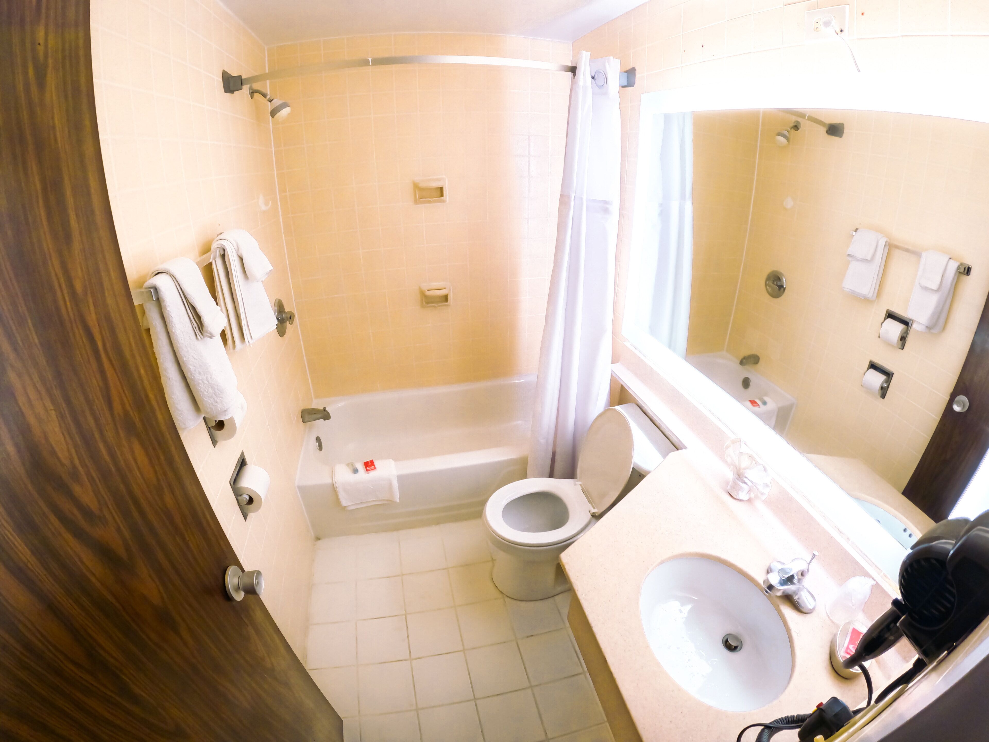 A bathroom with a bathtub, toilet, and sink.