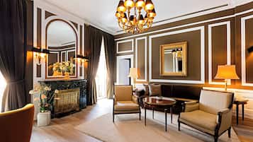 A well-appointed living room with a fireplace, comfortable seating, and elegant decor.