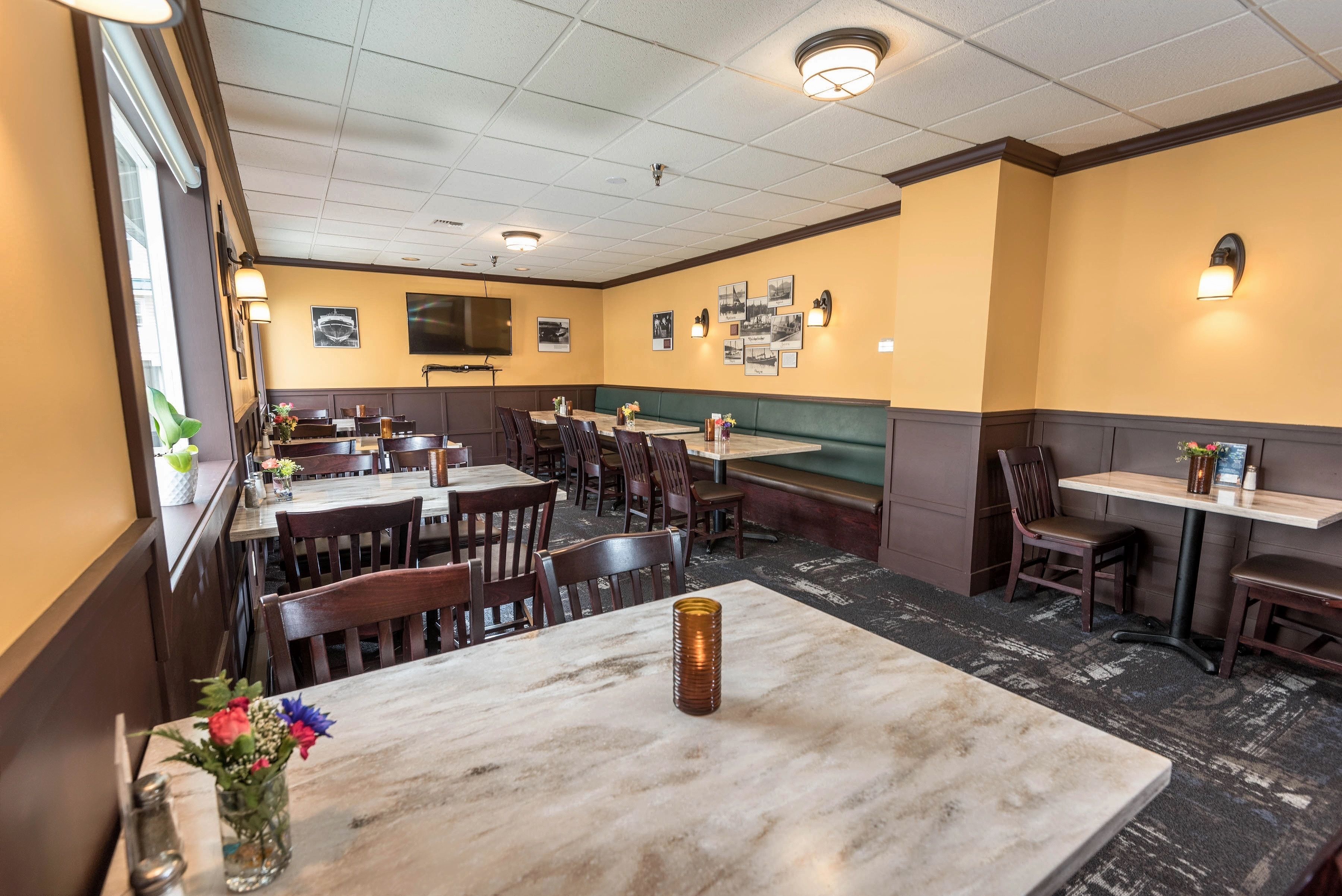 A restaurant interior with booths, tables, and a counter.