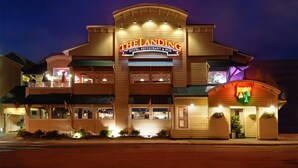 A multi-story hotel with a prominent sign reading "The Landing Hotel, Restaurant & Pub."