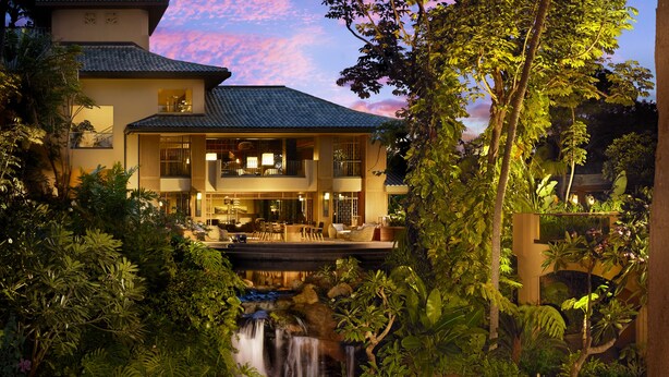 A two-story hotel with a waterfall, lush greenery, and a balcony overlooking the water. - Four Seasons Resort Lanai (Lanai City)