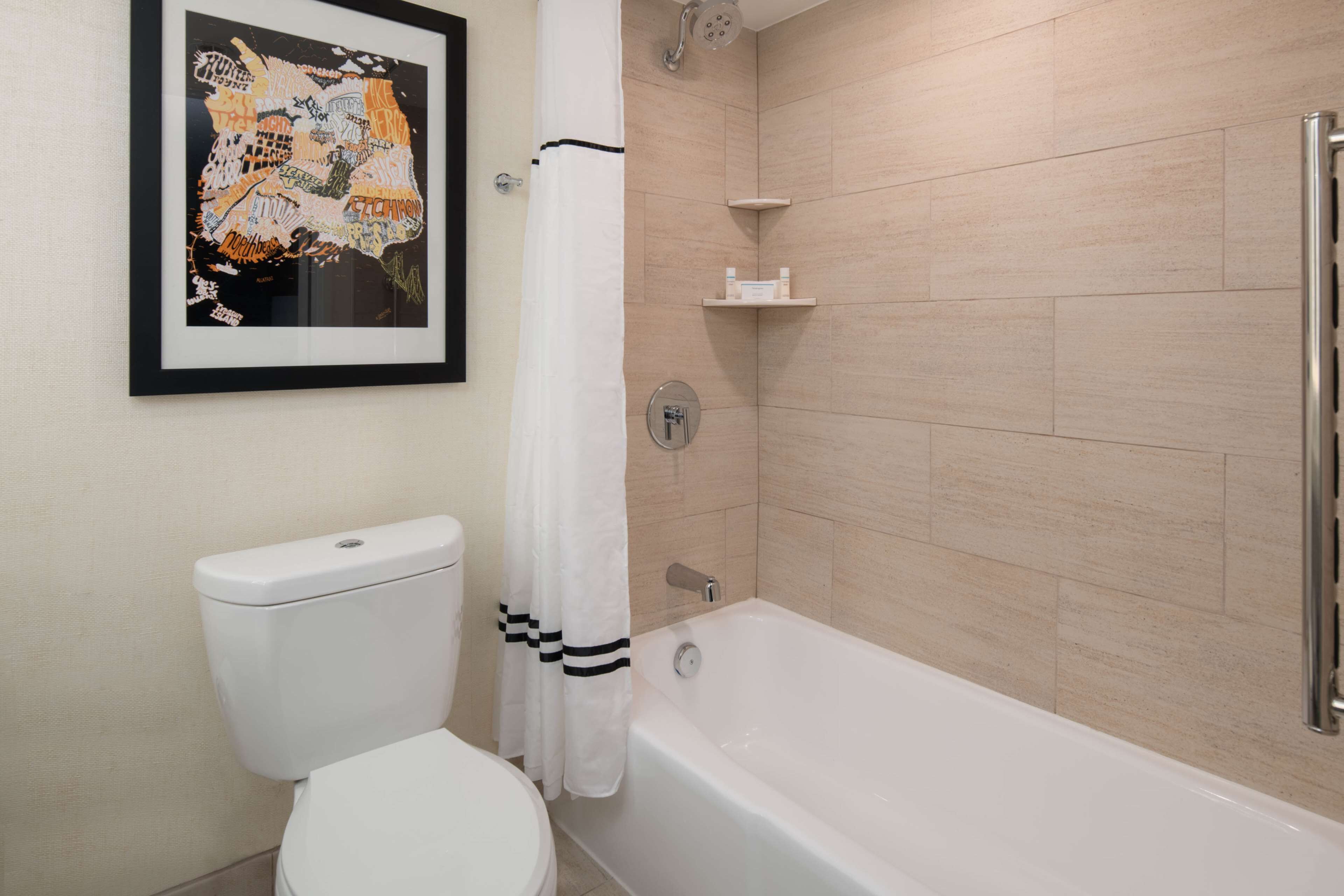 A bathroom with a toilet, a bathtub, and a shower.
