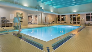 An indoor swimming pool with clear lane markings, a lifeguard chair, and pool rules posted on the wall. - Crowne Plaza Bowling Green KY by IHG (Bowling Green)