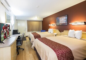 A hotel room with two beds, a desk with a computer, a TV, and a window with curtains. - Red Roof Inn Cincinnati - Sharonville (Sharonville)