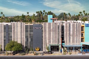 The Clarendon Hotel with a modern facade, a prominent sign, and a view of palm trees in the background. - The Clarendon Hotel & Spa, BW Signature Collection (Phoenix)