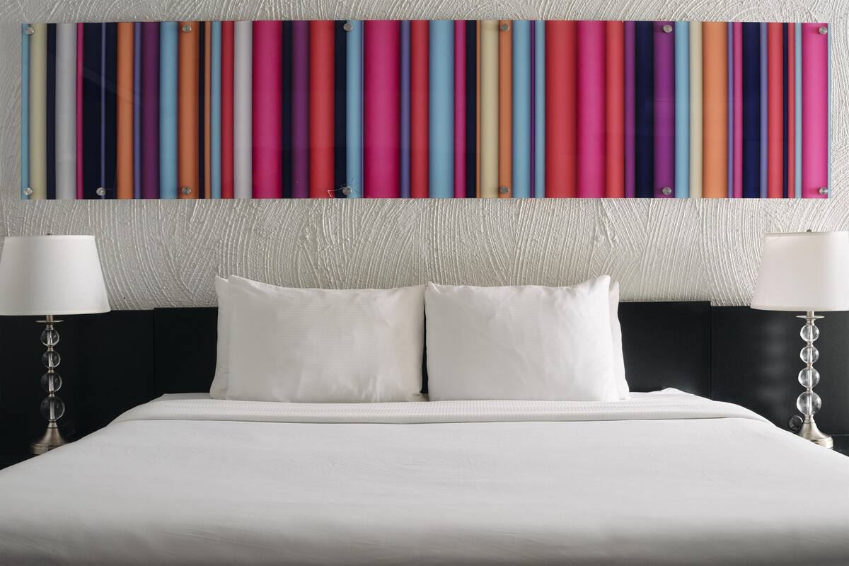 A bed with white bedding, two white pillows, and a headboard.