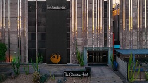 The Clarendon Hotel with a modern facade, a prominent logo, and a well-maintained entrance area.