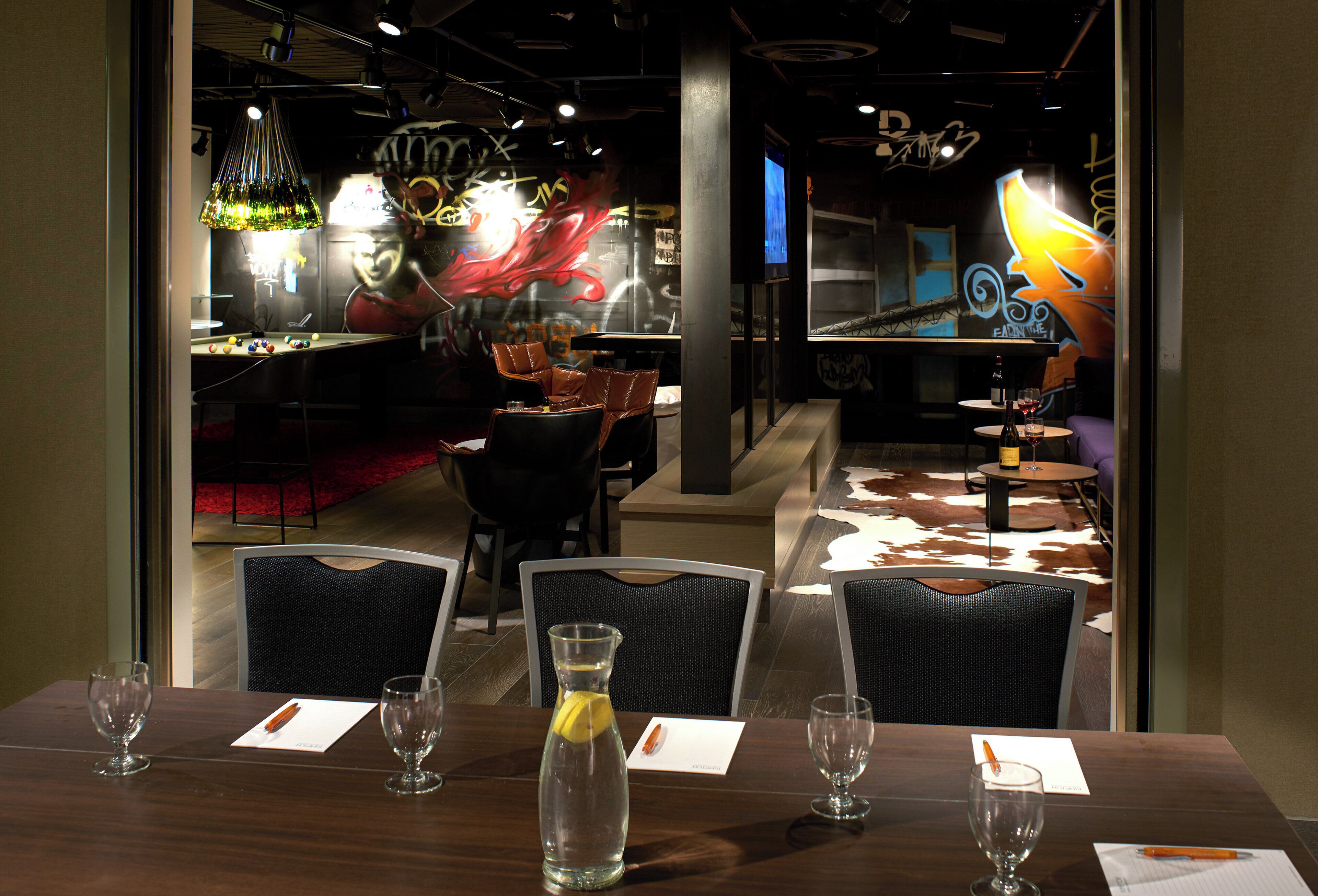 A restaurant interior with a pool table, bar area, and seating with a cowhide rug.