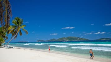 On the beach, white sand, sun loungers, beach towels