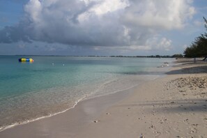 On the beach, white sand, sun loungers, beach umbrellas