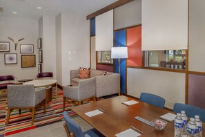 A hotel room with a conference table, two armchairs, a sofa, and a patterned rug. - Crowne Plaza St. Louis Airport by IHG (Bridgeton)