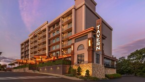 A multi-story hotel with balconies, a restaurant on the ground floor, and a stone facade. - Best Western Plus Waltham Boston (Waltham)
