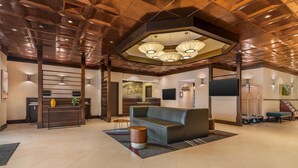 A spacious lobby with a reception desk, a leather sofa, and a modern ceiling design. - Best Western Plus Waltham Boston (Waltham)
