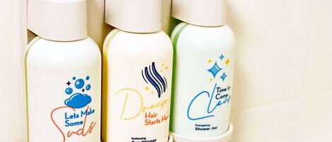 Three bottles of hair care products on a shelf.