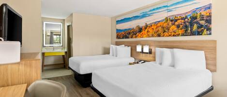 A hotel room with two beds, a desk, a chair, a TV, and a large painting on the wall.