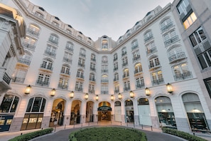 A historic building with a central courtyard, ornate balconies, and illuminated windows. - Steigenberger Icon Wiltcher's (Brussels)