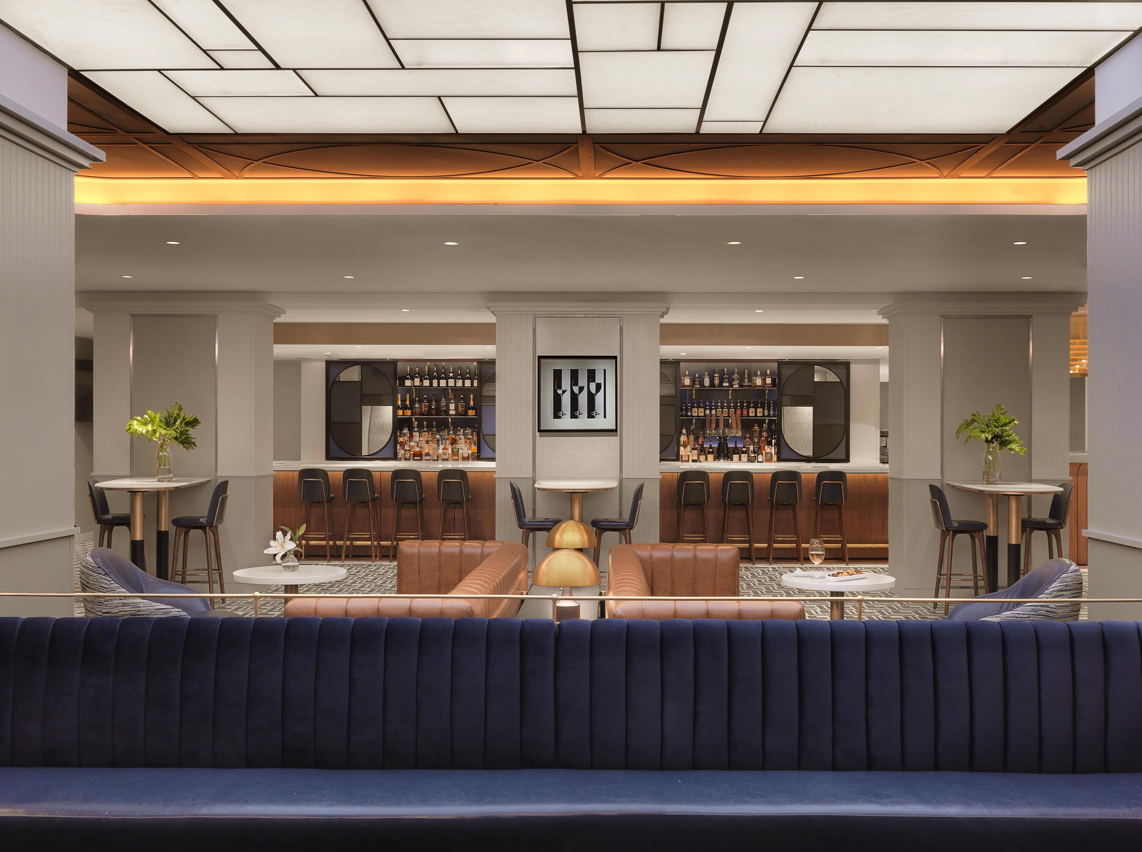 A modern bar area with seating and a bar counter.