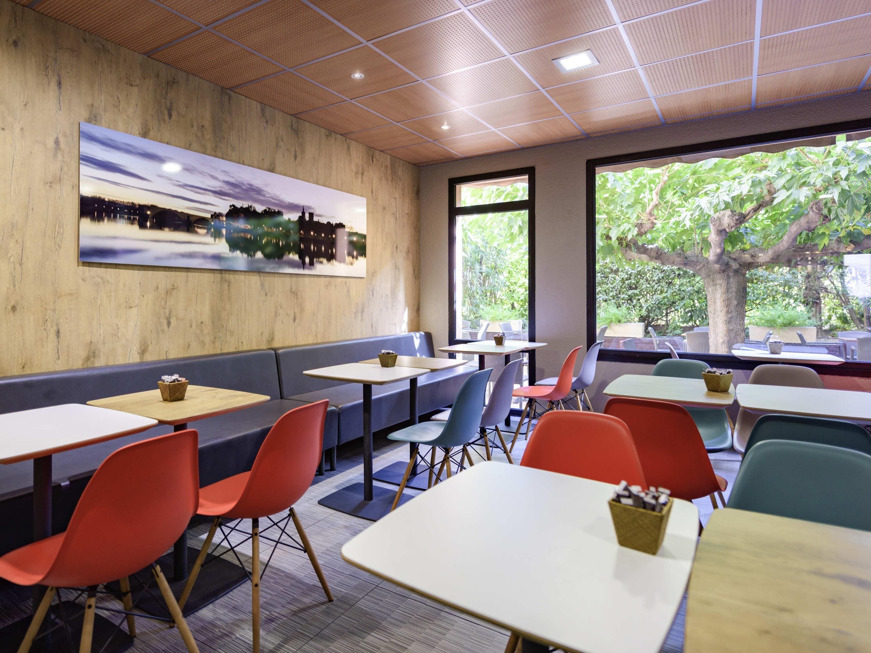A restaurant with booths, tables, and chairs.