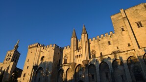 A historic castle with multiple towers and arched windows. - ibis Avignon Centre Pont de l'Europe (Avignon)