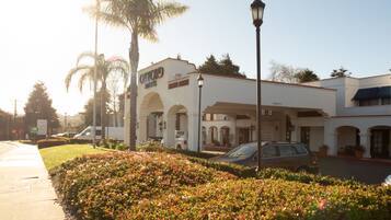 Classic hotel with arched doorways and beautifully maintained gardens.