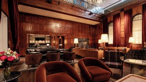 A spacious lobby with a grand staircase, a fireplace, and multiple seating areas. - Heathman Hotel (Portland)