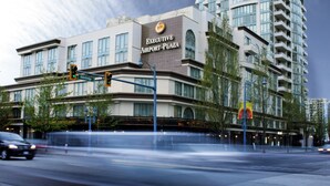 A multi-story hotel with a prominent sign reading "Executive Airport Plaza." - Executive Hotel Vancouver Airport (Richmond)