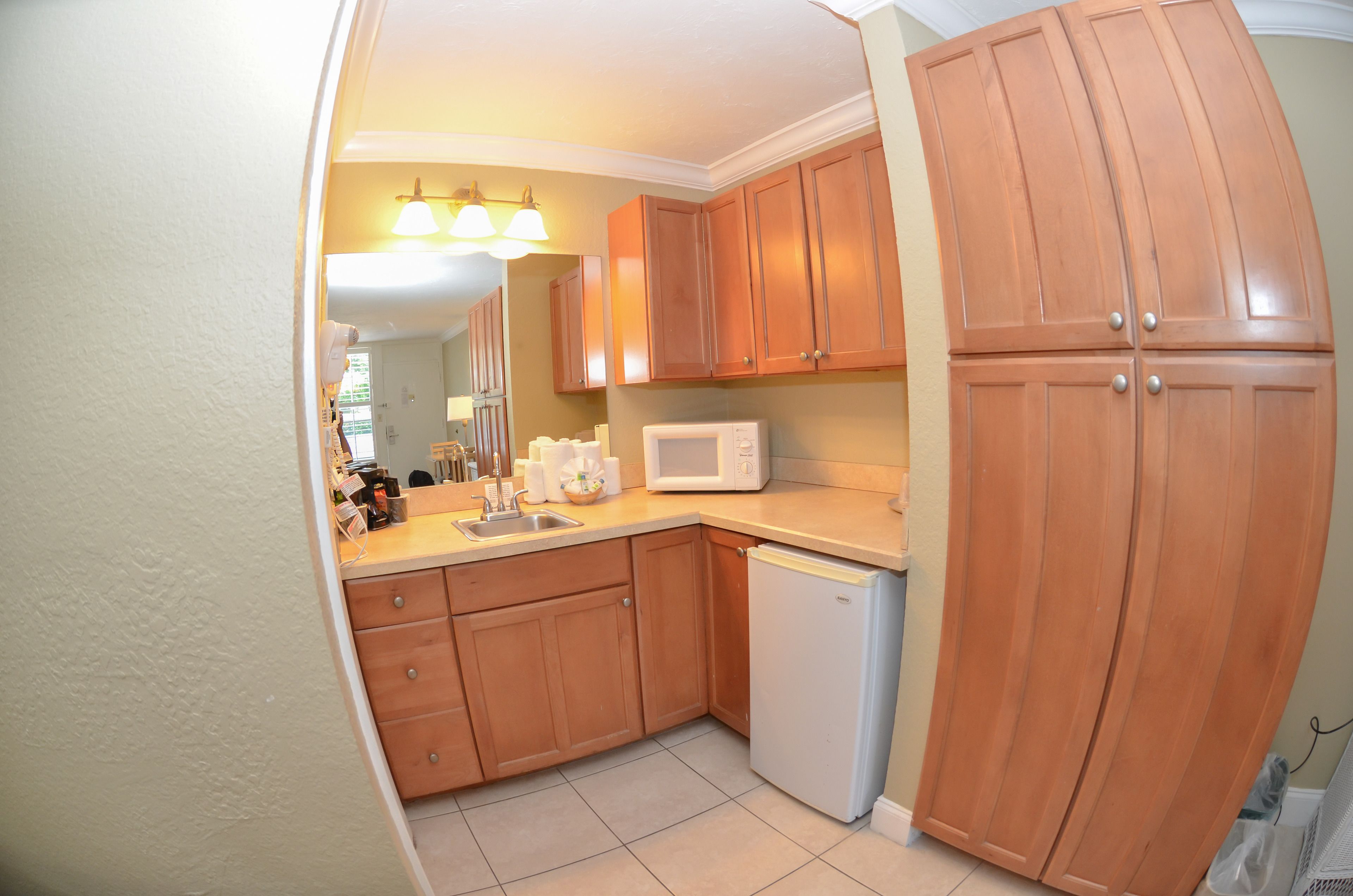 A kitchen with wooden cabinets, a microwave, and a dishwasher.