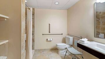 A bathroom with a shower, toilet, and sink.
