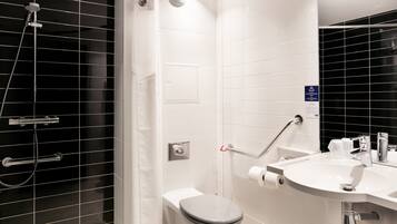 A modern bathroom with a shower, toilet, and sink.