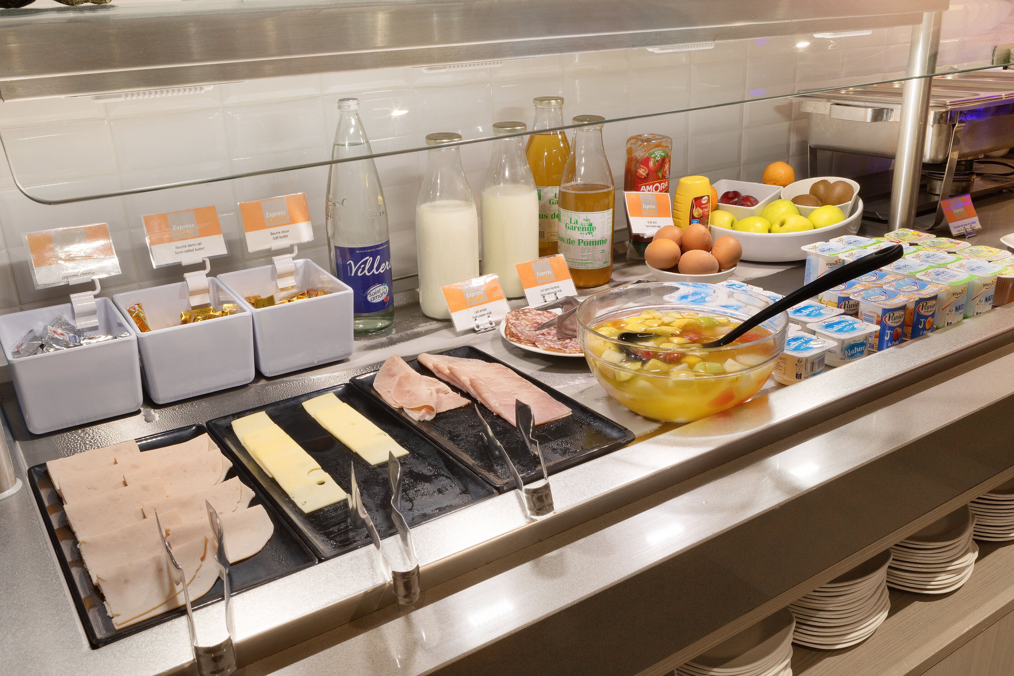 A buffet with various food items and condiments.