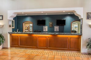 Reception area with a flat-screen TV, comfortable seating, and a welcoming atmosphere.