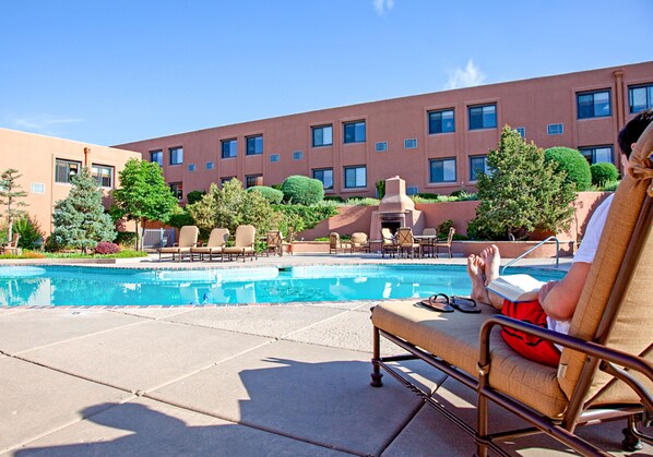 Seasonal outdoor pool, open 9:00 AM to 10:00 PM, pool umbrellas