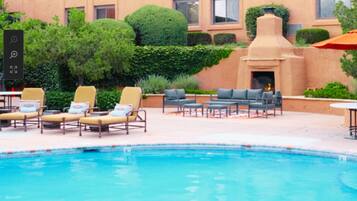 Seasonal outdoor pool, open 9:00 AM to 10:00 PM, pool umbrellas