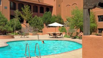 Seasonal outdoor pool, open 9:00 AM to 10:00 PM, pool umbrellas