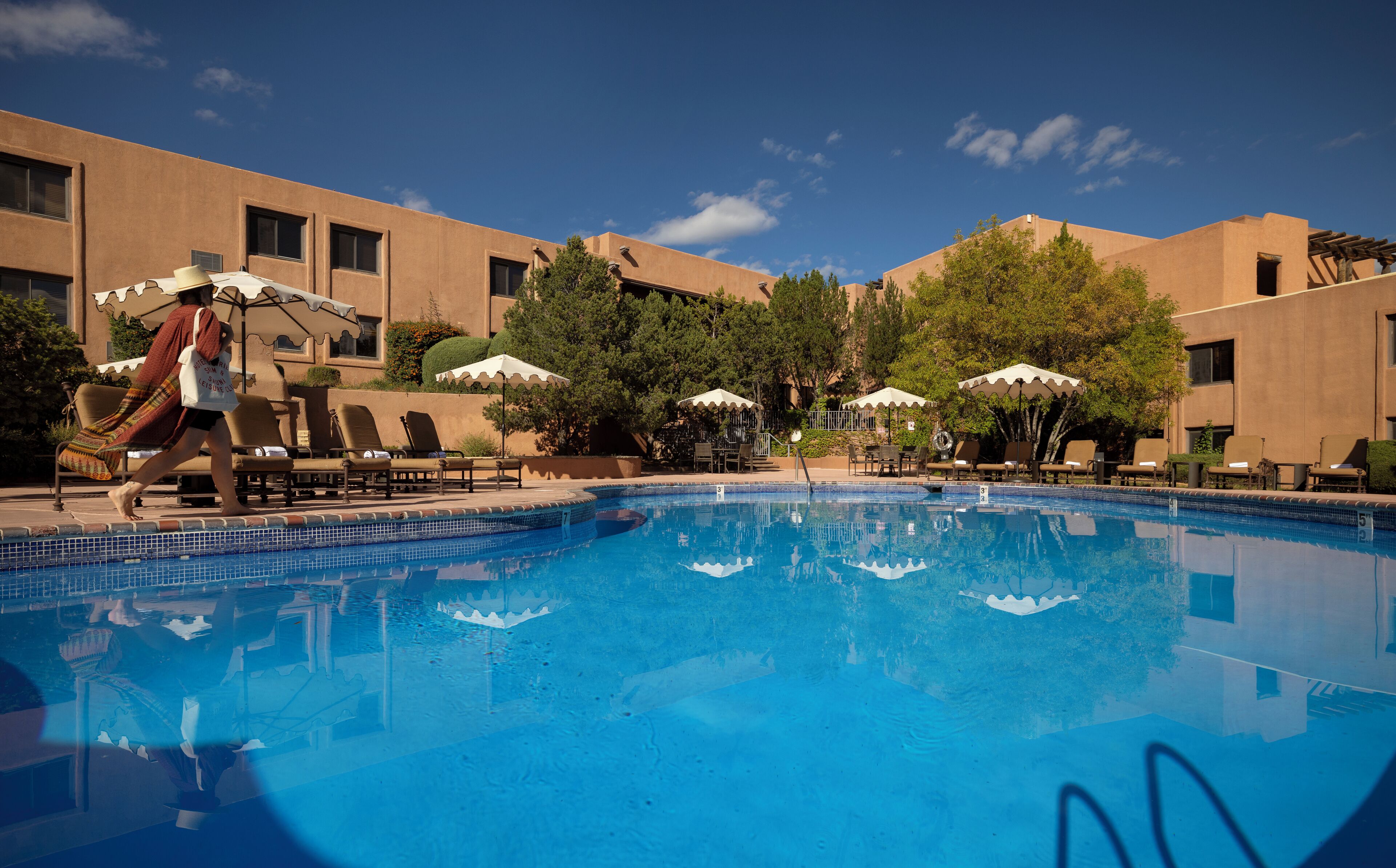 Seasonal outdoor pool, open 9:00 AM to 10:00 PM, pool umbrellas