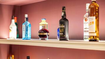 A shelf with various liquor bottles.
