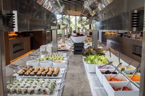 A buffet with various food options including sushi, salads, and other dishes.