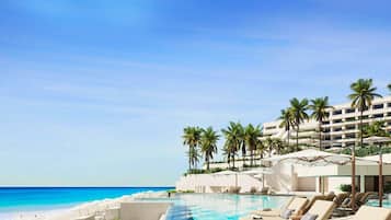 On the beach, white sand, beach umbrellas, beach towels