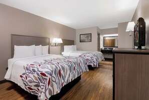 A hotel room with two beds, a desk, a mirror, and a window. - Red Roof Inn Chattanooga - Lookout Mountain (Chattanooga)