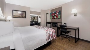 A hotel room with a bed, desk, chair, television, and a mirror. - Red Roof Inn Chattanooga - Lookout Mountain (Chattanooga)