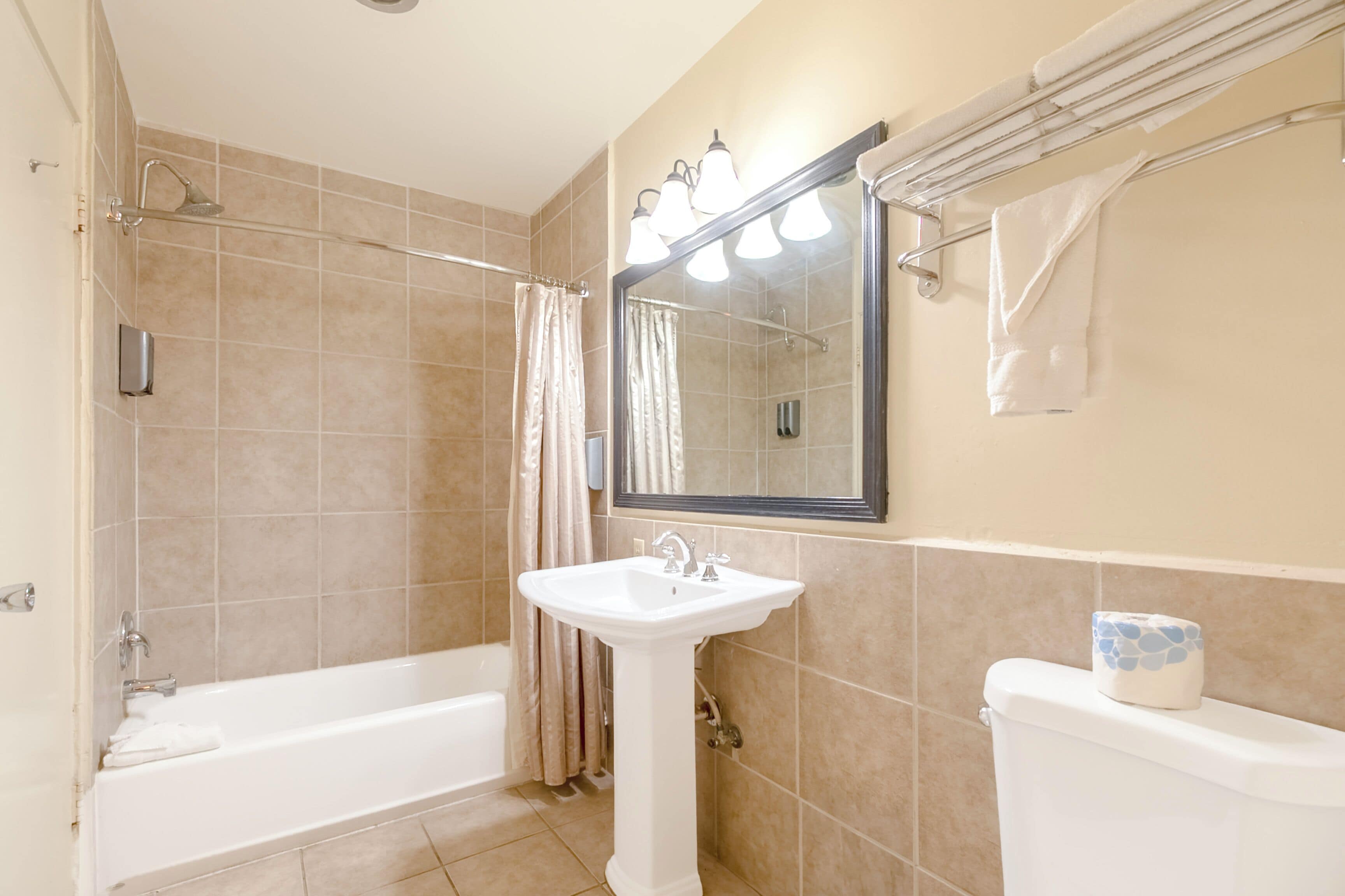 A bathroom with a bathtub, a sink, and a toilet.