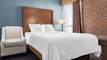 Premium bedding, desk, laptop workspace, blackout drapes