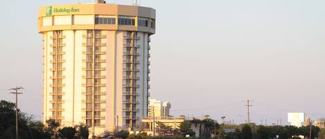 A tall hotel building with a prominent sign at the top.