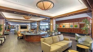A spacious lobby with a central bar area, comfortable seating, and a modern ceiling design. - Austin Southpark Hotel (Austin)