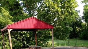 A gazebo with a picnic table in a park. - Nation's Inn Kinston (Kinston)