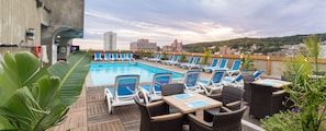 Seasonal outdoor pool, open 8:00 AM to 8:00 PM, pool loungers