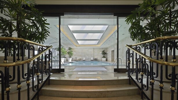 A staircase leading to a pool area with a skylight above. - The Sherwood Taipei (Taipei)